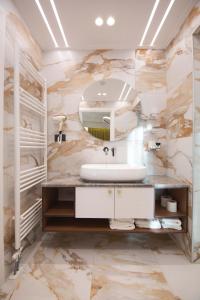 a bathroom with a sink and a mirror at Sky Hotel Korce in Korçë +257 photos