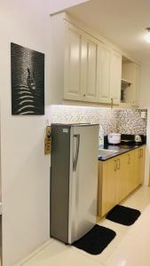 a kitchen with a stainless steel refrigerator at The Wind Escape Netflix-Ready Staycation for 4 in Tagaytay