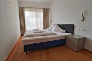 a bedroom with a large bed with a window at Panorama Chalet in Mittersill