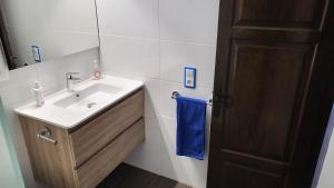a bathroom with a sink and a blue towel at Acacies 25 in Torroella de Montgrí +24 photos
