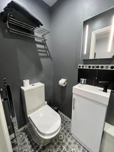 a bathroom with a white toilet and a sink at Addison House in Woking +31 photos
