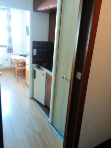 a kitchen with a door open to a kitchen with a table at Appartement d'une chambre avec jardin clos et wifi a La Salle les Alpes in La Salle Les Alpes
