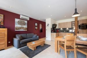 a living room with a couch and a table at ALPES Annecy Rent Lodge in Annecy