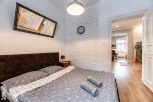 a bedroom with a bed and a brick wall at Apartament w centrum Karpacza, MyWeek in Karpacz