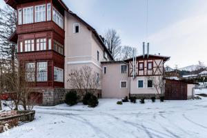 a large house in the snow in front at Apartament w centrum Karpacza, MyWeek in Karpacz