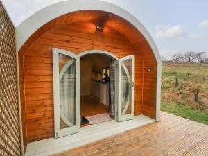 a circular house with an arched door and windows at Otter in Keighley