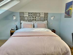 a bedroom with a large bed with pink sheets at LUX Studio Loft in London