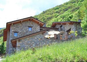 a stone house on the side of a mountain at B&B Casa Val in Quincinetto