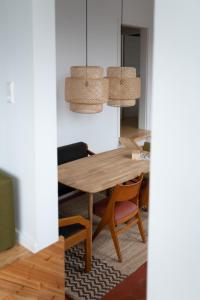 a dining room with a wooden table and chairs at 80 Quadratmeter Komfortzone in Braunlage +18 photos