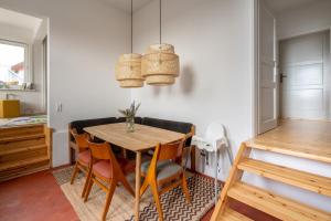a dining room with a wooden table and chairs at 80 Quadratmeter Komfortzone in Braunlage