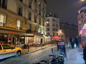 a city street at night with a car parked on the street at Grand H&ocirc;tel de Clermont in Paris
