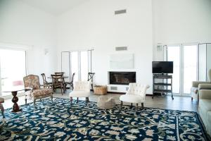a living room with a couch and chairs and a tv at Agro-Turismo Herdade do Carneiro in Escoural