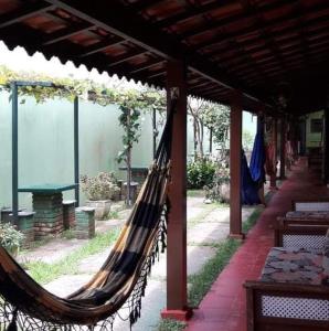 a hammock hanging from awning in a patio at Chale Colonial in Ubatuba