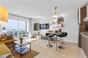 cocina y sala de estar con sofá y mesa en 2024 New Pools Wonderful Views AC, en Costa Teguise