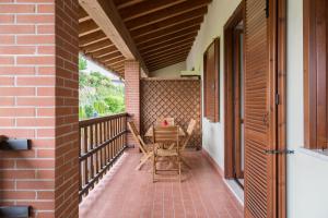 a balcony with a table and chairs on it at Manerba Sweet Apartment in Manerba del Garda