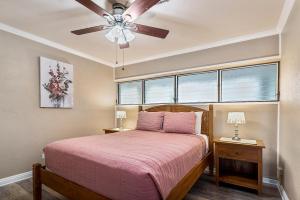a bedroom with a bed and a ceiling fan at Kalani Kai#104 in Kailua-Kona +18 photos