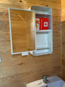 a bathroom with a mirror and a sink at CABANA DO SOL in Torres Vedras