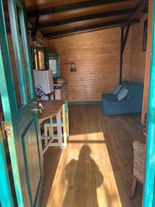 a room with a table and a blue couch at CABANA DO SOL in Torres Vedras