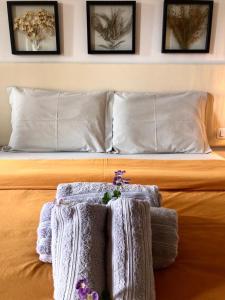 uma cama com cobertores brancos e flores em Oby Noronha em Fernando de Noronha