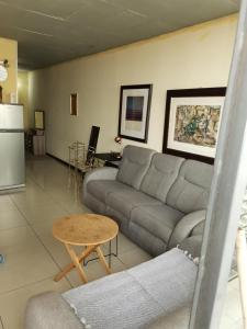 a living room with a couch and a table at Broadway flats Braamfontain in Johannesburg
