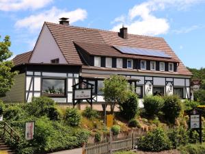 a black and white house with a solar roof at Gasthof "Zum Burghof" in Medebach