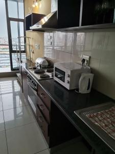 a kitchen with a microwave sitting on a counter at Broadway flats Braamfontain in Johannesburg