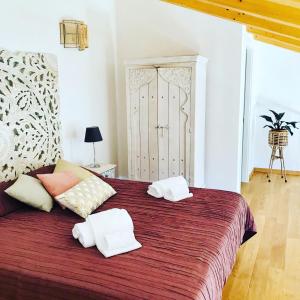 a bedroom with a large bed with two pillows on it at Agriturismo Le Pale 2 Swimming Pool and Parking in Bogliasco