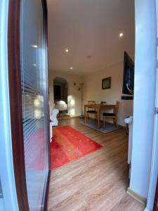 a living room with a red rug and a table at App 3 in List