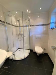 a bathroom with a shower and a toilet and a sink at App 3 in List
