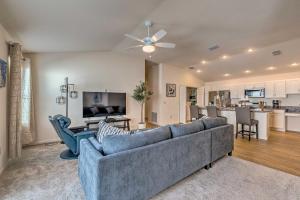a living room with a couch and a kitchen at Golfers Paradise - The Villages in Wildwood! in Wildwood