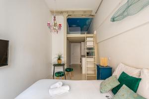 a small bedroom with a bed and a ladder at BNBHolder Oasis GRAN VIA in Madrid