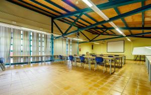 a conference room with tables and chairs and a whiteboard at Camping Alberg Municipal Tivissa in Tivissa +51 photos