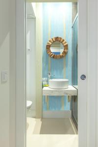 a bathroom with a sink and a mirror on the wall at BNBHolder Oasis GRAN VIA in Madrid