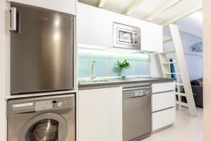 a kitchen with a washing machine and a sink at BNBHolder Oasis GRAN VIA in Madrid