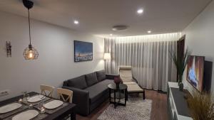 a living room with a couch and a table at Cervinia Apartment 2121 - Ski & Mountain Panorama in Breuil-Cervinia