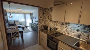 a kitchen with a table and a dining room at Cervinia Apartment 2121 - Ski & Mountain Panorama in Breuil-Cervinia +28 photos