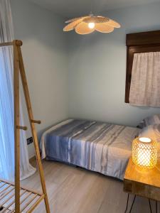 Habitación con cama, lámpara y mesa. en SIERRA NORTE-TERVILOR, en Canencia