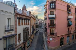 an empty street in a city with buildings at Plaza Nueva Deluxe Suite by Valcambre in Seville