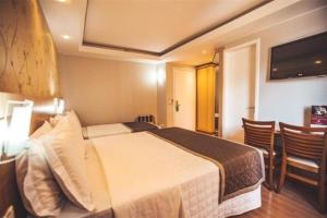 Postel nebo postele na pokoji v ubytování Hotel Rafain Centro