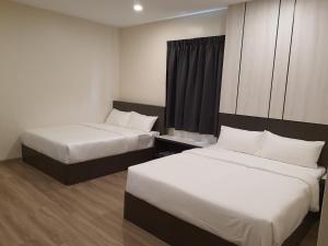 Rúm í herbergi á T SQUARE HOTEL (IPOH)