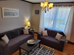 a living room with two couches and a table at The Harbourside Inn & Cafe in Port Union