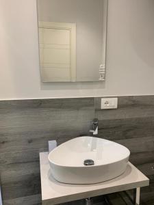 a white sink in a bathroom with a mirror at Helvetia Garibaldi in Genoa