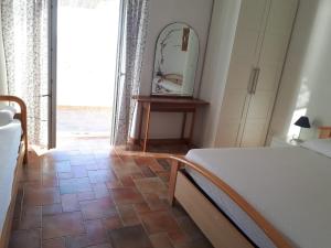 a bedroom with a bed and a mirror on the wall at Villetta Frasena in Santa Maria