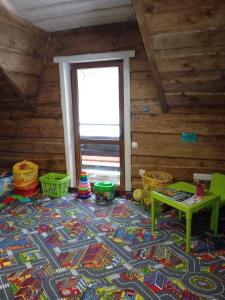 a room with a rug on the floor with a table at Сімейний Затишок апартаменти FAMILY HOME будиночок in Tysovets