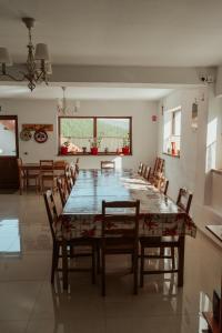 a dining room with a table and chairs at Casa Bunicutei in Ranca
