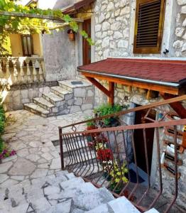 a patio with a wooden table and a building at Aleksa in Cetinje