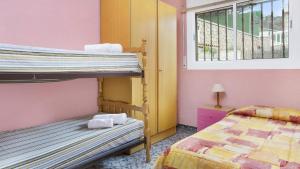 a bedroom with two bunk beds and a window at 2Vil01 - Lloret de Mar in Lloret de Mar