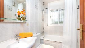 a bathroom with a sink and a toilet and a window at 2Vil01 - Lloret de Mar in Lloret de Mar +11 photos