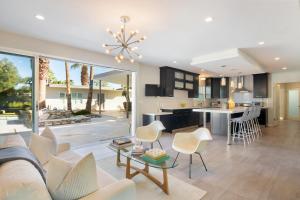 a living room with a couch and a table at Modern Palms in Palm Springs