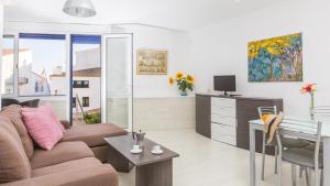 a living room with a couch and a desk at 1Solive - Calella de Palafrugell in Calella de Palafrugell
